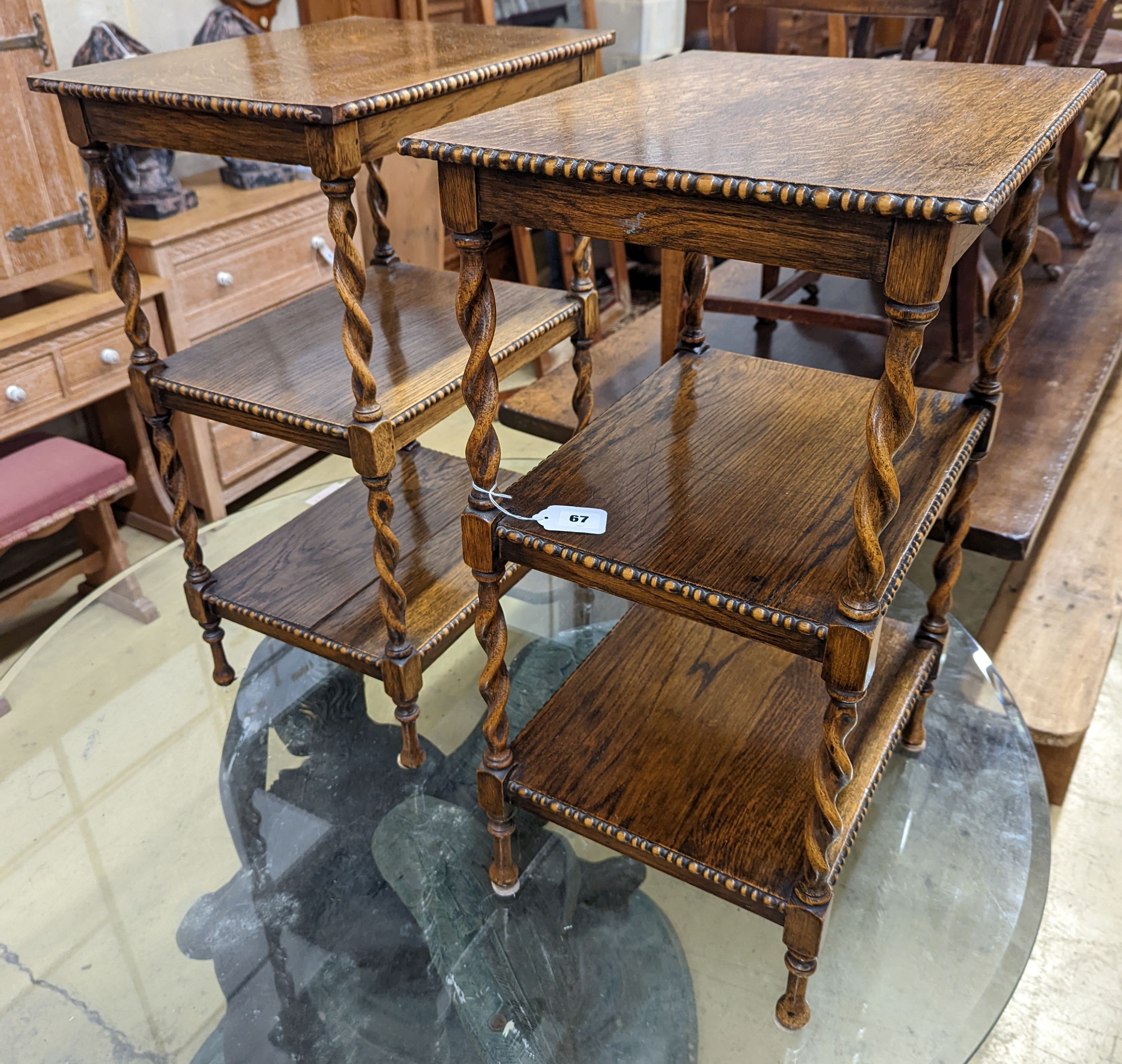 A pair of oak three-tier whatnots. W-46cm, D-36cm, H-69cm.